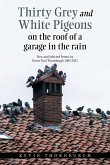 Thirty Grey and White Pigeons on the Roof of a Garage in the Rain