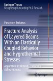 Fracture Analysis of Layered Beams With an Elastically Coupled Behavior and Hygrothermal Stresses